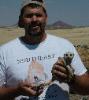Rodney Moore at gobobos / brandberg mining camp with a meerkat