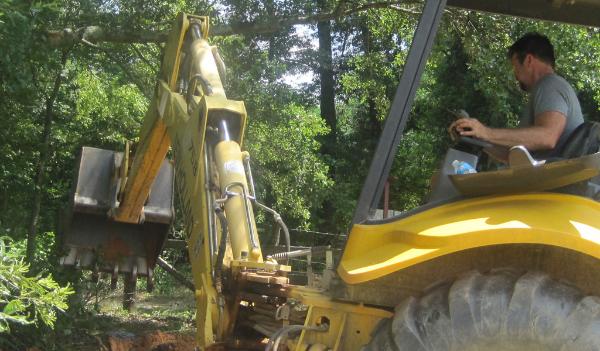Rodney Moore digging amethyst crystals with his backhoe